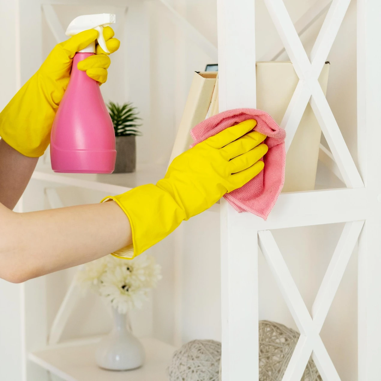 unrecognizable female hands yellow protective gloves washing shelf stand with detergent