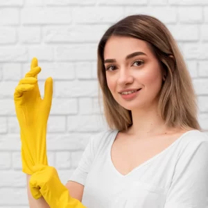 side view woman putting cleaning gloves