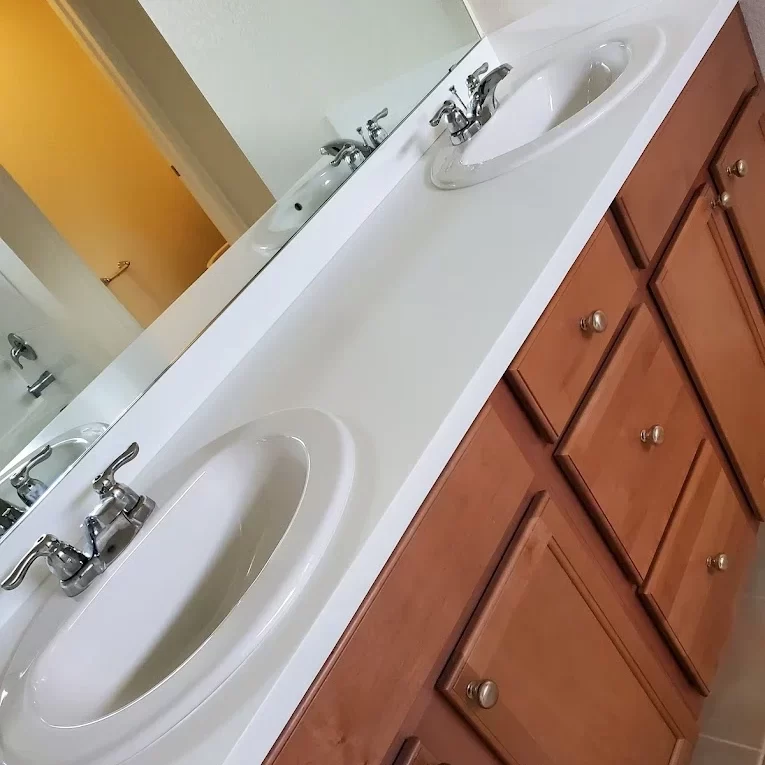 A white sink in a clean restroom after Rapro Cleaning service in Denver.