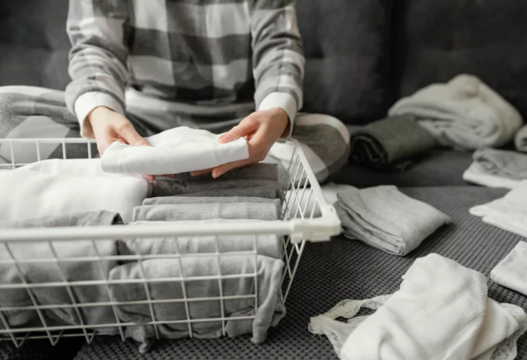 A close-up photo of a woman arranging clothes.