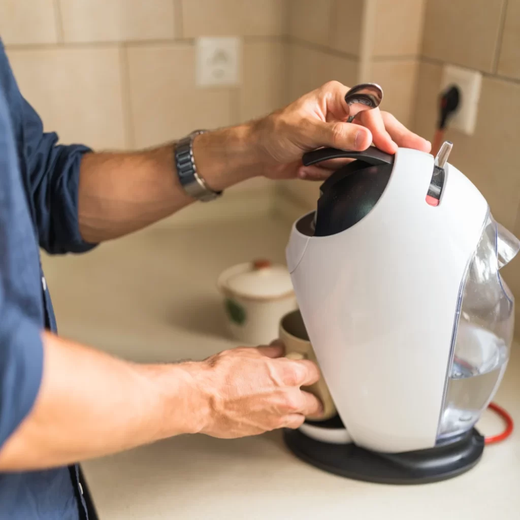 Close-up of a man cleaning small appliances in and around Denver.