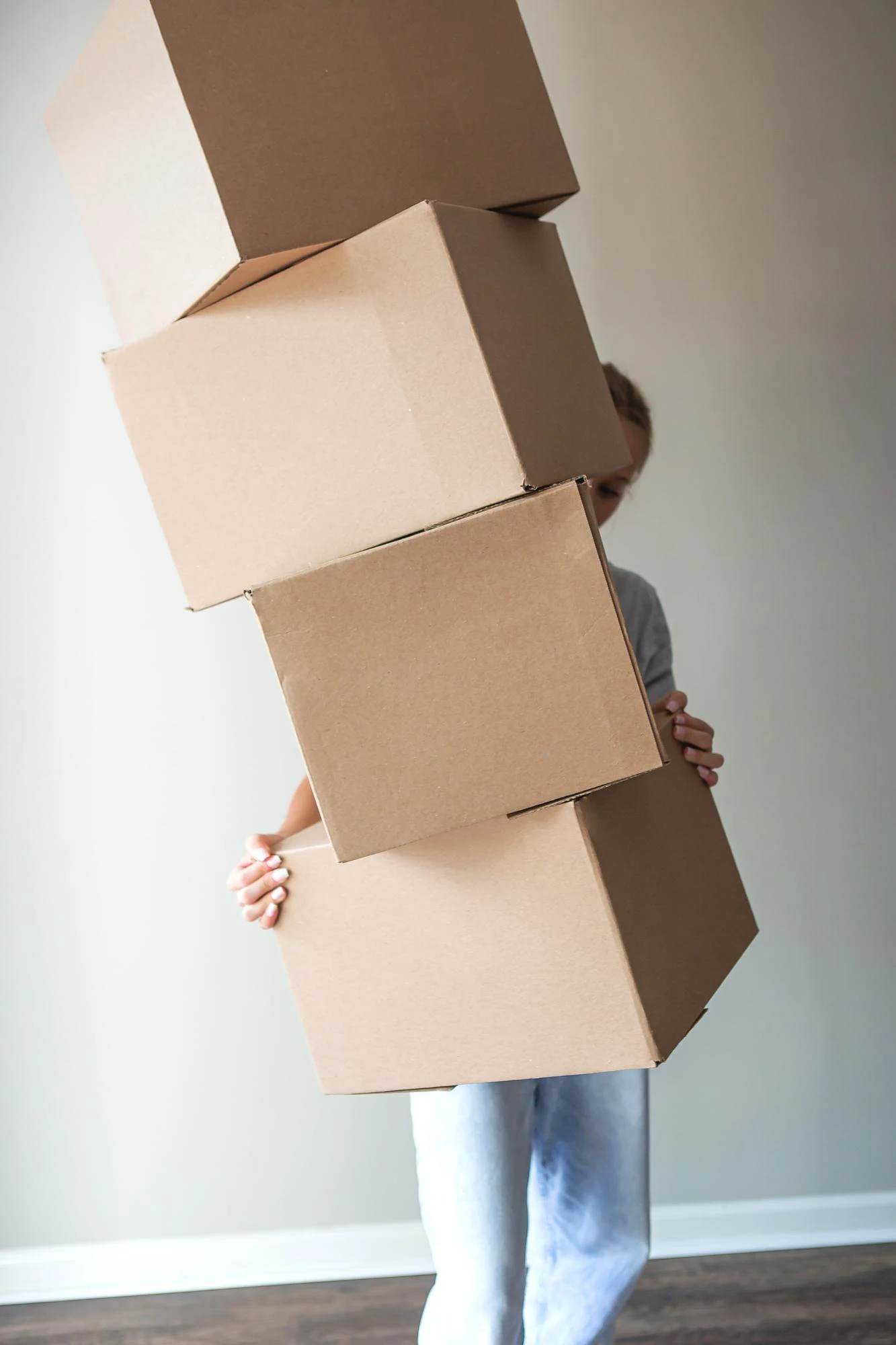 happy girl moving to new home with boxes on her hand