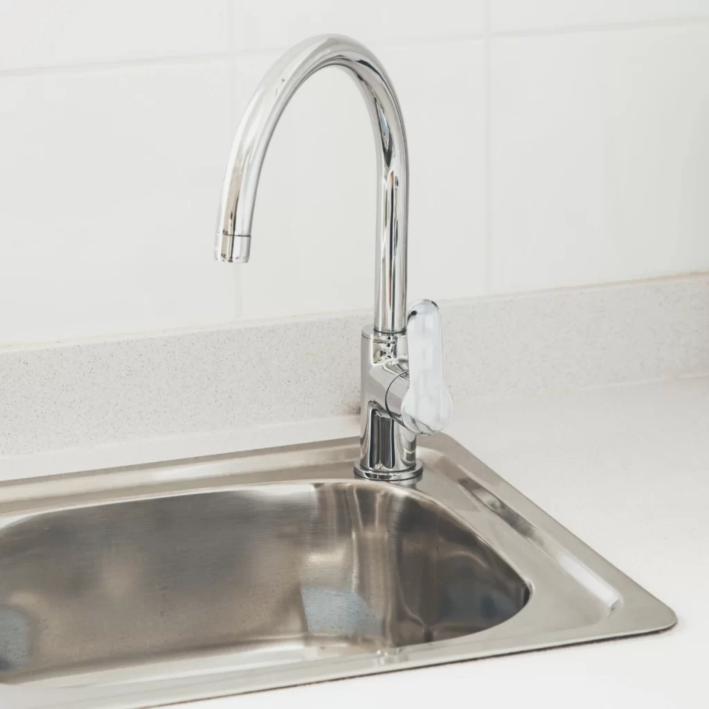 kitchen faucet with near white wall