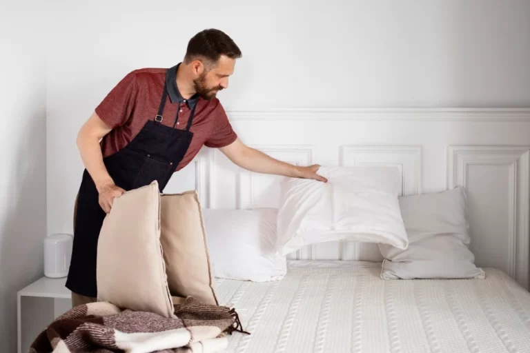 a cleaning man making bed