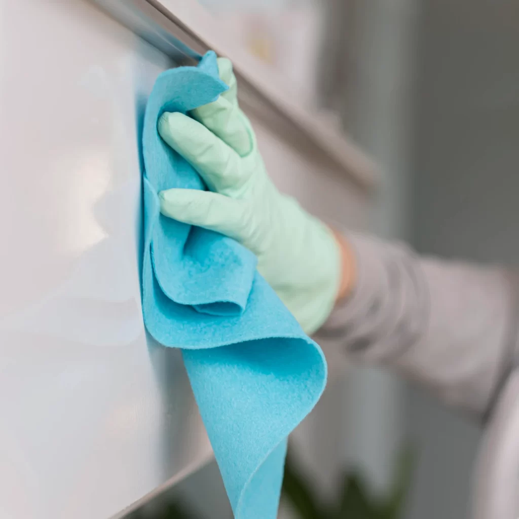 side view hand with glove cleaning surface with cloth