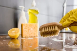 Person wearing protection gloves using a brush